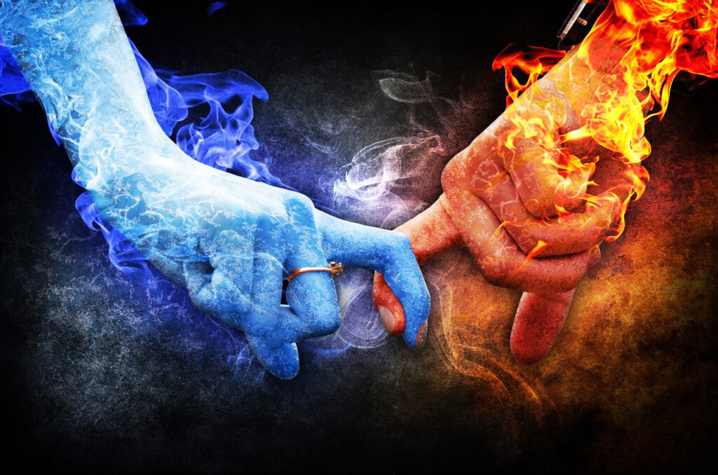 Two hands wearing wedding rings with pointer fingers intertwined. One hand is blue and one is red. Both are surrounded by flames of their own color.